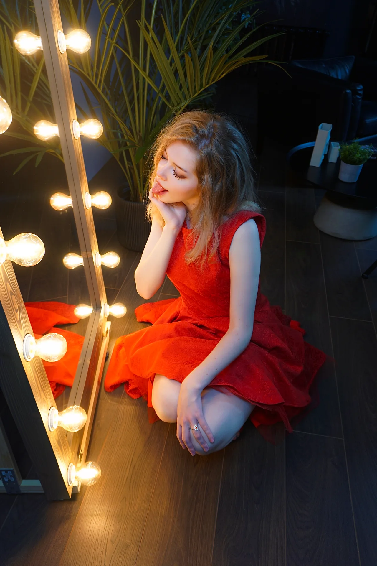 Kneeling in a red dress