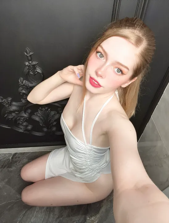 White romper by a black door